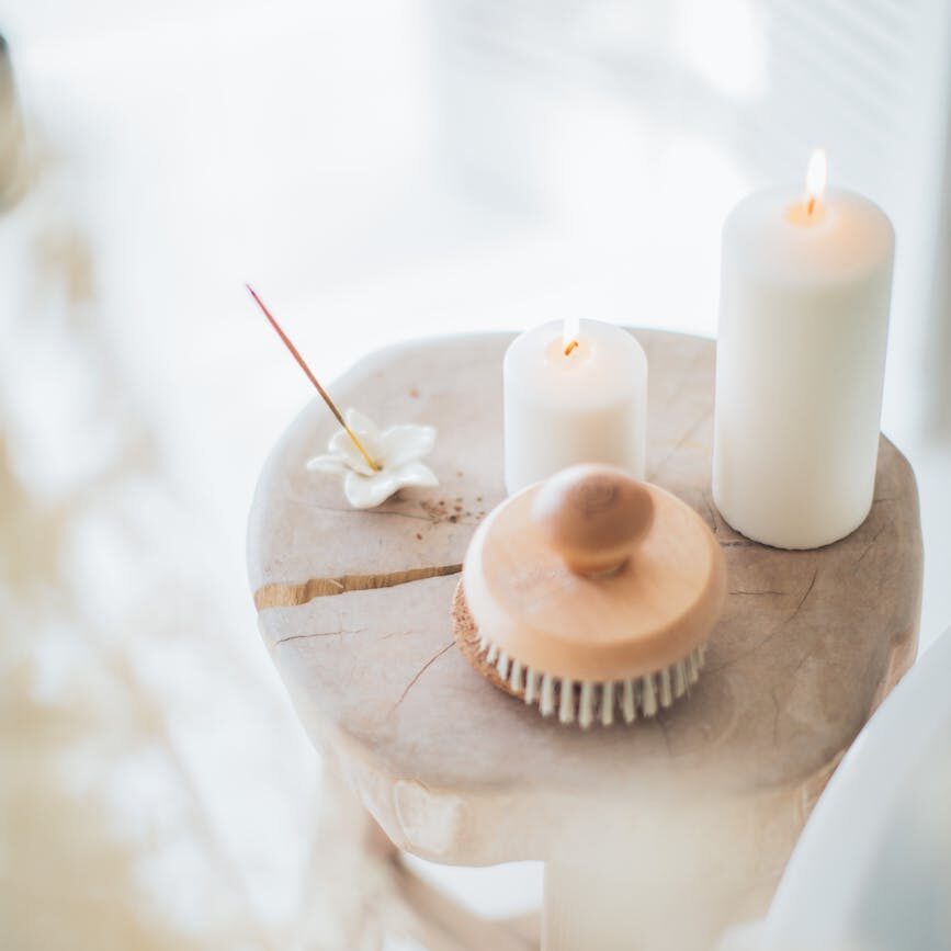 incense and white candles on a stool