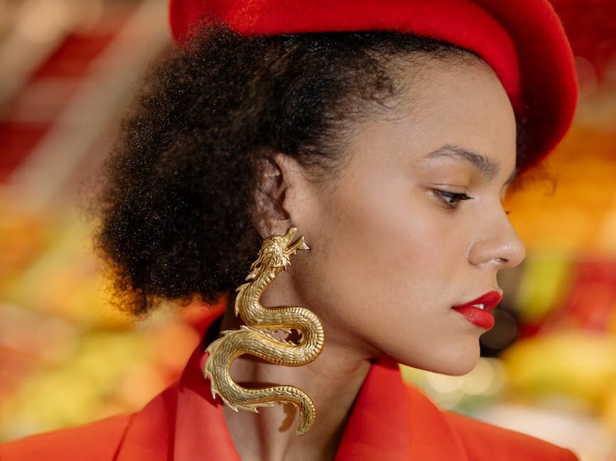 woman in red beret wearing gold earring